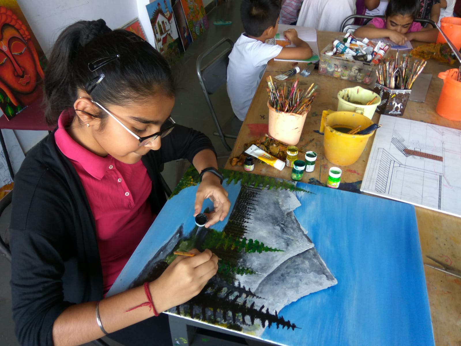 Student painting mountain landscape